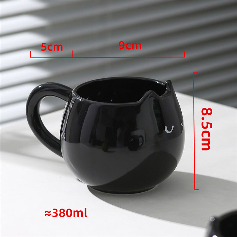 Adorable hand - painted cat - shaped ceramic mug, perfect for coffee or tea.